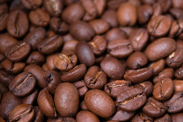 close up of Freshly roasted coffee beans background. top view