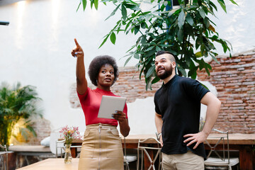 Restaurant manager giving instructions to facilities guy