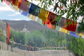 Buddhist religious flags hanging at Mulbekh, ladakh. Himalayan mountains in background, Ladakh, Jammu and Kashmir, India