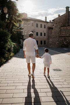 Fototapeta Father and son walking in the city