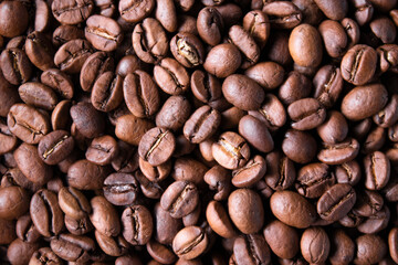 close up of Freshly roasted coffee beans background. top view