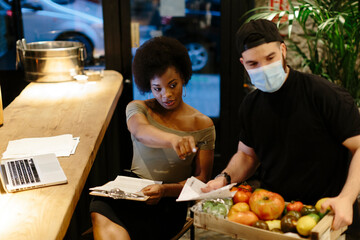 Restaurant manager receiving daily food deliveries.
