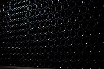 Wine bottles in wine cellar, row of glass bottles