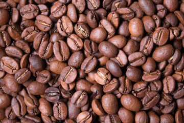 close up of Freshly roasted coffee beans background. top view