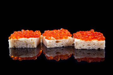 salmon caviar sandwiches on a black background