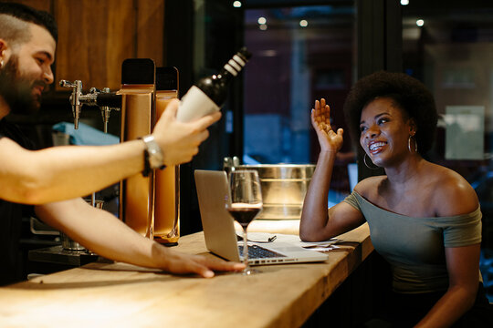 Restaurant staff sharing a drink at the end of their shift