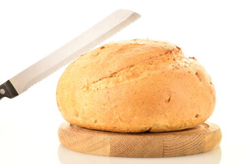 One loaf of delicious white bread with a metal knife on a wooden tray, close-up, isolated on white.