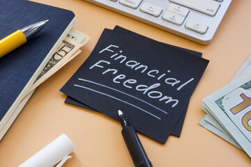 Financial freedom memo with cash and keyboard. © Vitalii Vodolazskyi