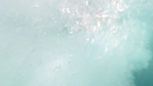 slowmotion close up shot of boat propeller in action with air projection during a sunny day