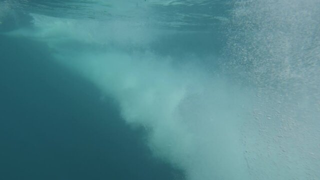 slowmotion close up shot of boat propeller starting in deep blue sea during a sunny day