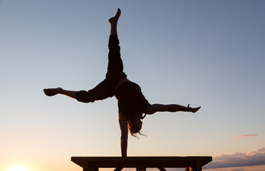 One arm handstand at sunset