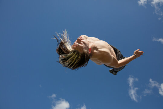 Young man spinning in the air