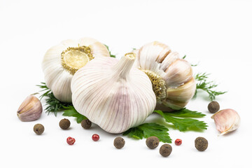 Heads of garlic, parsley and dill, mixture of peppers isolated on a white background.
