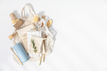 Plastic free set with cotton bags, cleaning tools, Reusable bottle, bamboo cutlery and toothbrushes top view on white background