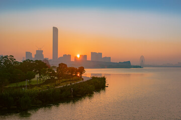 Naklejka premium sunset over the city or lake