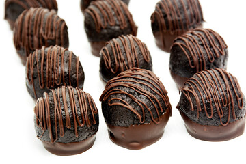 Chocolate truffles on white background. Pattern of homemade dark chocolate bitter truffles.