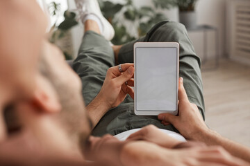 Man Holding White Screen Table while Relaxing