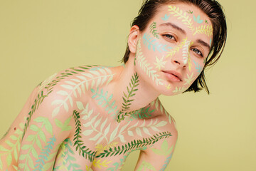 Beauty model with leaves pattern on her skin