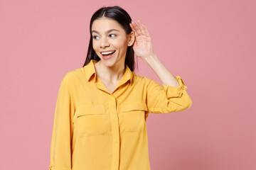 Young brunette cute latin curious smiling cute attractive woman 20s wearing yellow casual shirt try...
