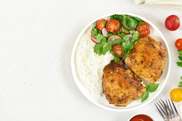Fried chicken thighs with vegetables in plate