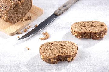 Crumbs and bread slices on light background. Close up.. Top view