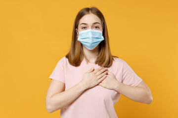 Young kind woman 20s iwear basic pastel pink t-shirt, sterile face mask to safe from coronavirus...