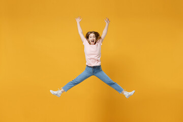 Fototapeta na wymiar Full length of young overjoyed energetic excited woman wearing basic pastel pink t-shirt jumping high with outstretched hands, legs look camera scream isolated on yellow background studio portrait