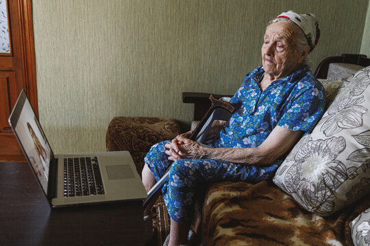 Old female having online session with family doctor