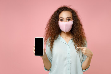 Young black african woman in blue shirt face mask, coronavirus covid19 pandemic quarantine point...