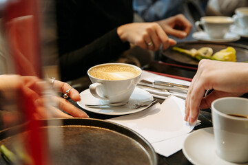 hands of a person drinking coffee