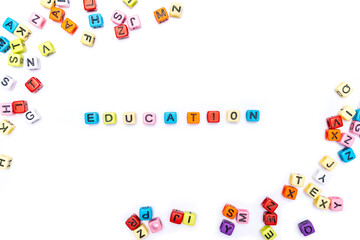 Cube beads collate in the word EDUCATION