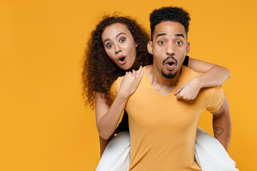 Young couple two friends together family african shocked surprised man woman with open mouth in...