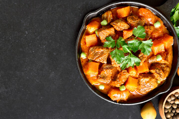 Beef stew with potatoes and carrots in tomato sauce