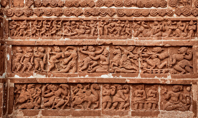 Relief work in the wall of a famous terracotta temple at Bishnupur, West Bengal, depicting Hindu mythological characters, Gods and goddesses, soldiers etc.