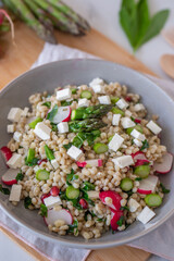 healthy spring salad with asparagus, barley and cheese
