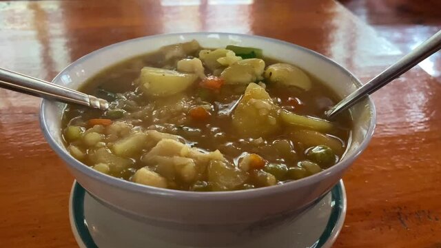A bowl of sherpa stew sitting on a table.