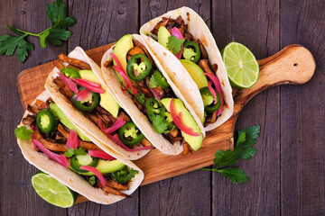 Vegan mushroom tacos. Serving board, above view on a dark wood background. Healthy eating, plant...