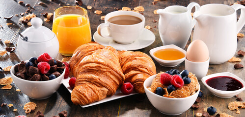 Breakfast served with coffee, juice, croissants and fruits