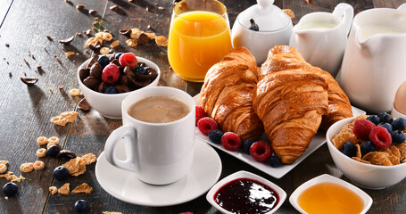 Breakfast served with coffee, juice, croissants and fruits