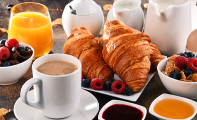 Breakfast served with coffee, juice, croissants and fruits