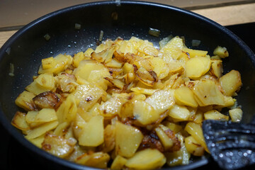 fried potatoes in a pan on the stove