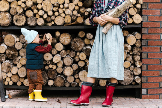 Boy helping mother to pick firewood