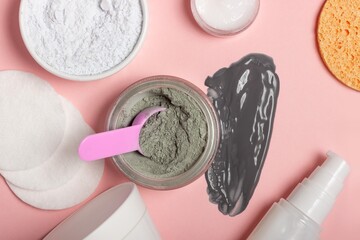 An open cosmetic jar, against the background of a smeared cream or cosmetic face mask. Purifying and moisturizing clay mask. Top view, flat lay
