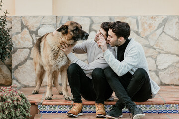 Portraits of a gay couple stroking their dog