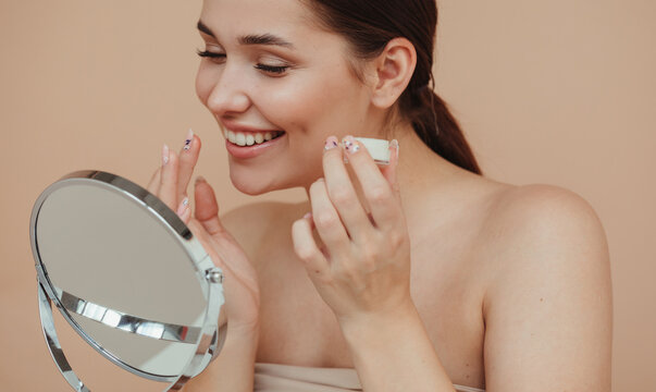 Smiling Model Applying Balm On Lips