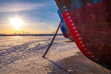The waterline of the barge that is anchored