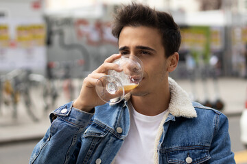Portrait of a caucasian man drinking beer on the terrace of a bar