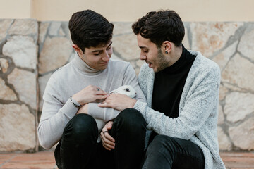 Portraits of a gay couple stroking their rabbit