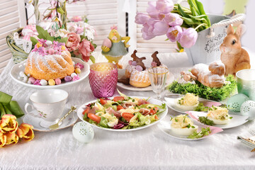 Easter breakfast with fresh salad stuffed eggs and traditional pastries