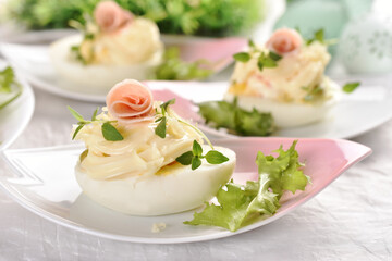 eggs with mayonnaise stuffed with vegetable salad on Easter table